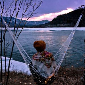 back view of a person sitting on a hammock